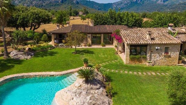A villa with a swimming pool, surrounded by lush greenery and mountains. - Villa Can Brullet by SunVillas Mallorca (Pollença)
