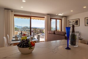 Enjoy a meal with a view of the marina and distant mountains from the dining area.