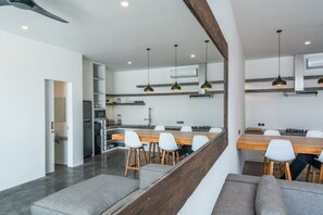 Enjoy cooking in this well-lit kitchen with a central island, oven, and stainless steel sink.