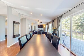 Enjoy meals in this dining area with a long table and comfortable seating for all.
