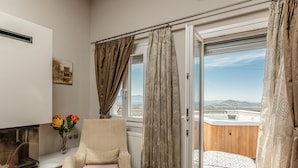 Une pièce avec vue sur un jacuzzi, un fauteuil et un vase rempli de fleurs.