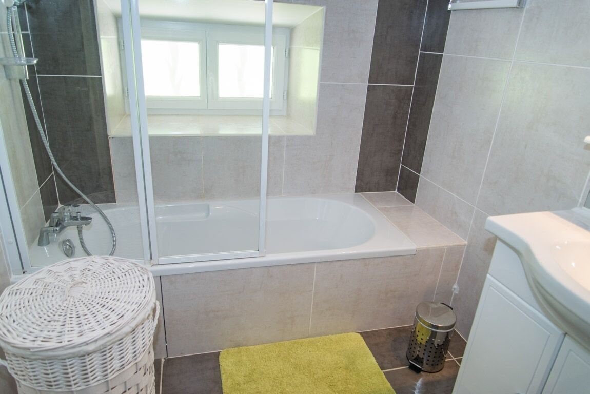 A bathroom with a bathtub, a shower, and a toilet.