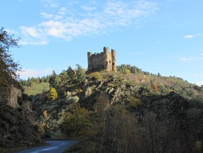 A castle on a hill with a road leading to it. - Gîtes de France 11 people in Le Teil (ALBARET LE COMTAL)