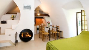A cozy, modern loft with a fireplace, dining area, and kitchen. - House (SAINTE-ENIMIE)