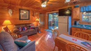 A cozy cabin interior with a wooden floor, a sofa, a dining table, and a kitchen area. - ☆Augst Week Day Openings☆ 
 (Murphy)