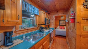 A wooden cabin interior with a kitchen, a bed, and a fire extinguisher. - ☆Augst Week Day Openings☆ 
 (Murphy)