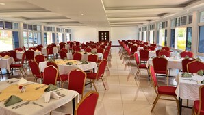 A large banquet hall with rows of tables and chairs, large windows, and a high ceiling. - Tom Mboya Labour College (Kisumu)