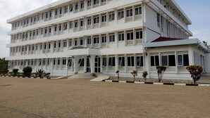 A multi-story building with a flat facade, large windows, and a covered entrance area. - Tom Mboya Labour College (Kisumu)
