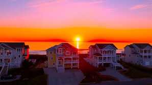 A coastal residential area with houses during sunset.