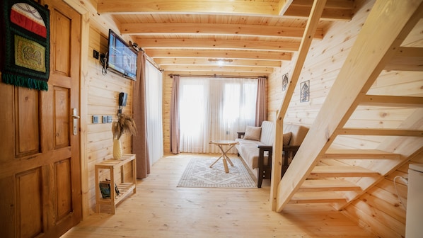 A wooden interior with a staircase, a sofa, and a small table. - My Home Hotel Antalya City Center (Antalya)