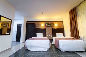 A hotel room with two beds, a large mirror, a wooden headboard, and a nightstand with a lamp. - Alpha-Plus Apartments 91 Utako (Abuja)