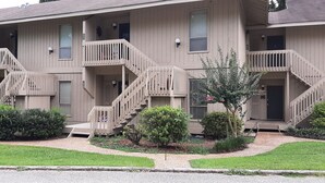 A multi-story apartment building with a uniform exterior, multiple balconies, and a well-maintained garden area. - DAPHNE -  MOBILE BAY CONDO - Great location  (Daphne)