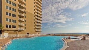 A hotel with a large pool, a beach view, and multiple balconies. - *Aug 29 - Sept 3 Open! *Beautiful, Gulf Front!* (Panama City Beach)