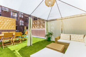 A tented outdoor area with a sofa, chairs, and a table. - NEW! Private garden, hot tub, lounge chairs, barbecue (Marrakech)