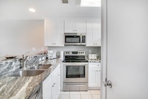 Enjoy cooking and dining in this functional kitchen with stainless steel appliances, double sink, and clean lines.