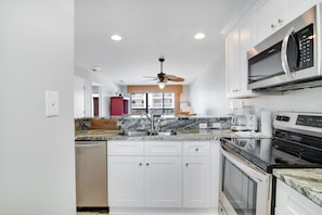 Enjoy cooking in this well-equipped kitchen with a microwave, oven, and dishwasher.