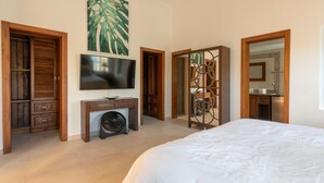 Une chambre à coucher avec un lit, une télévision, un bureau et une armoire.