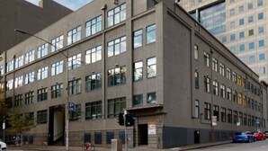 A multi-story building with a symmetrical facade, large windows, and a visible entrance. - Wiltshire | Large & Spacious (Melbourne)