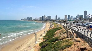 A coastal cityscape with a beach, promenade, and high-rise buildings. - Seafront penthouse - terrace, AC, lift & parking (Tel Aviv-Yafo)