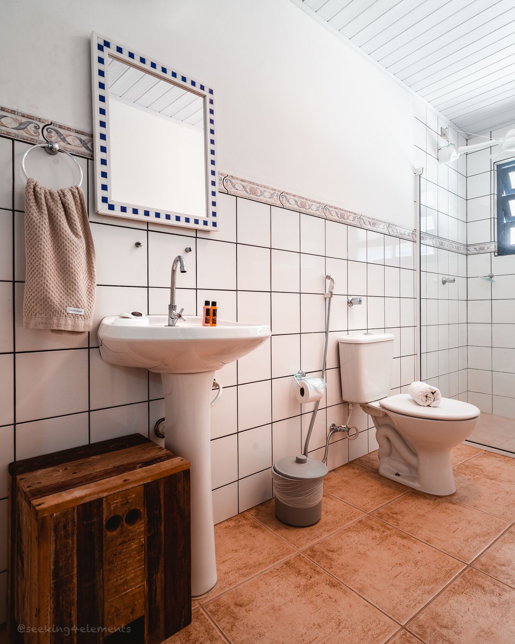 A bathroom with a sink, toilet, and mirror.