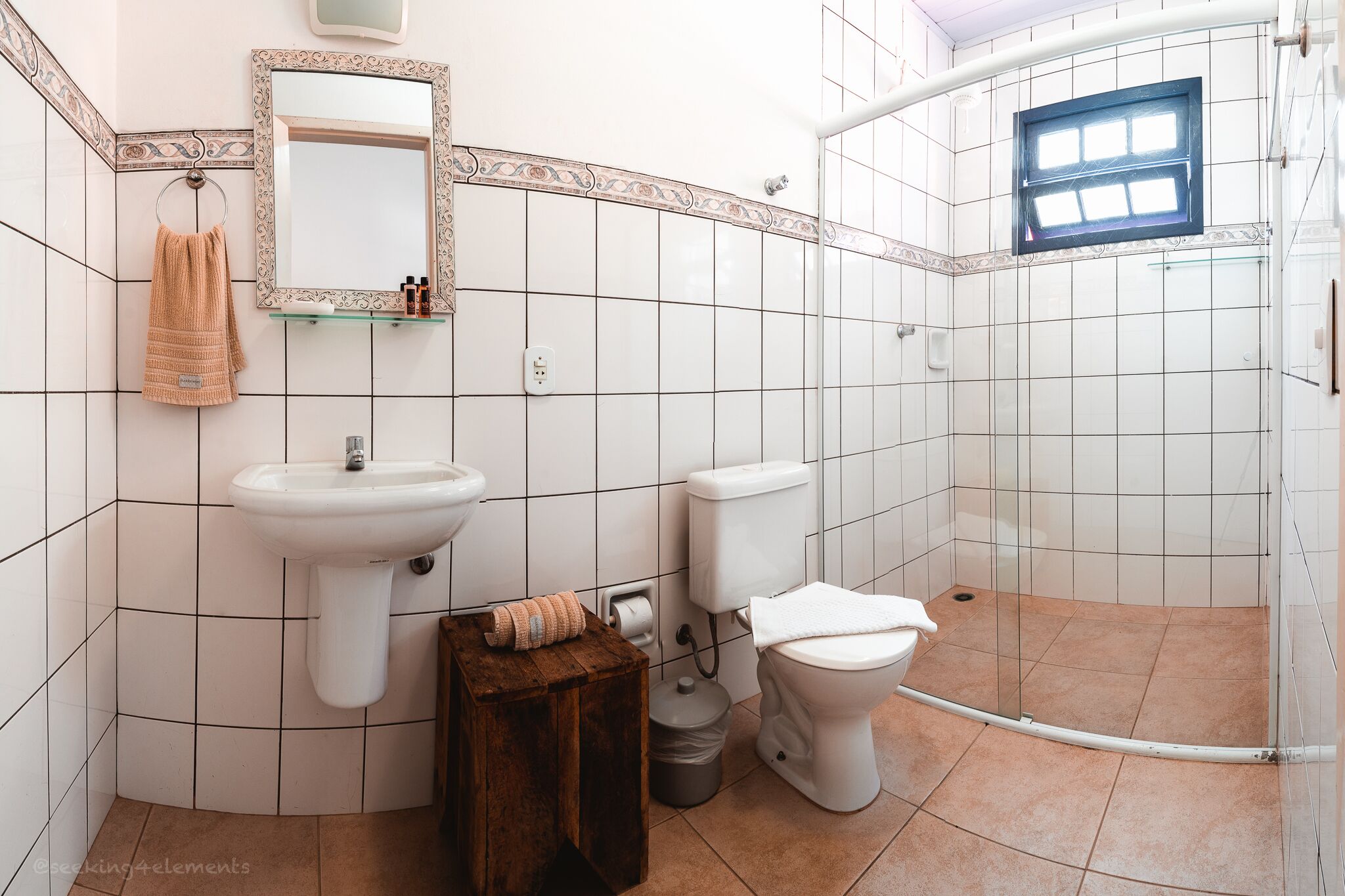 A bathroom with a sink, toilet, and shower.