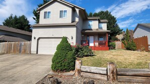 A two-story house with a front porch, a garage, and a well-maintained lawn. - A Wine Country  Home (Lafayette)