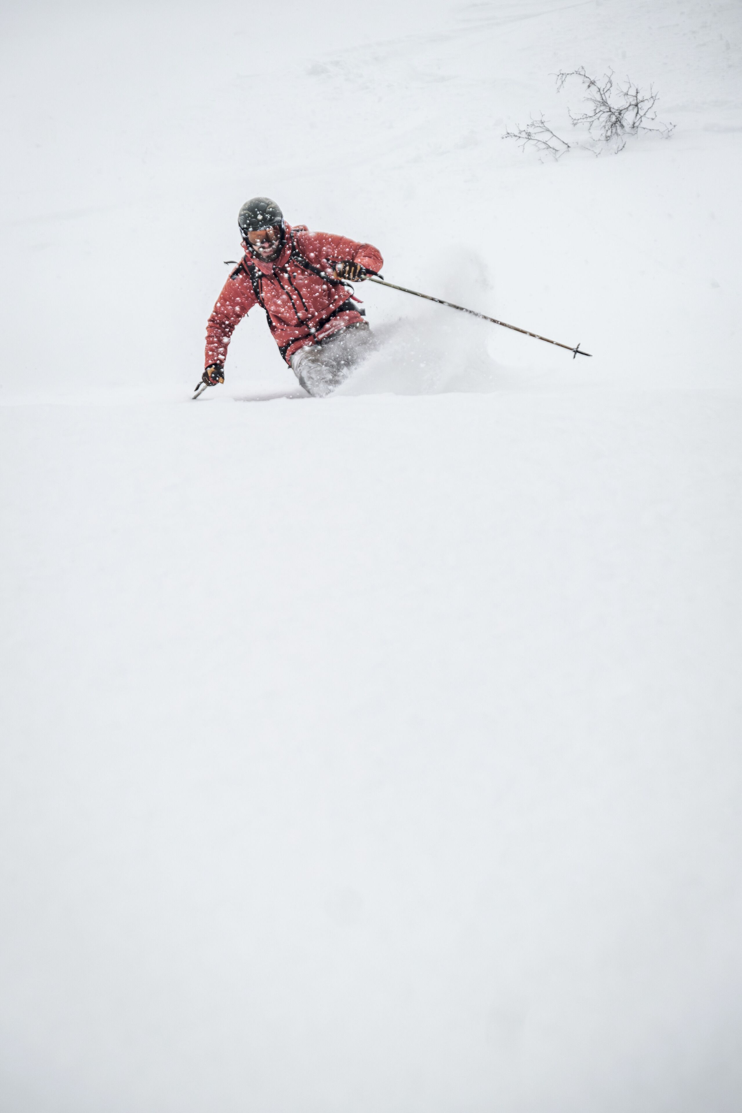 A person skiing down a snowy slope.