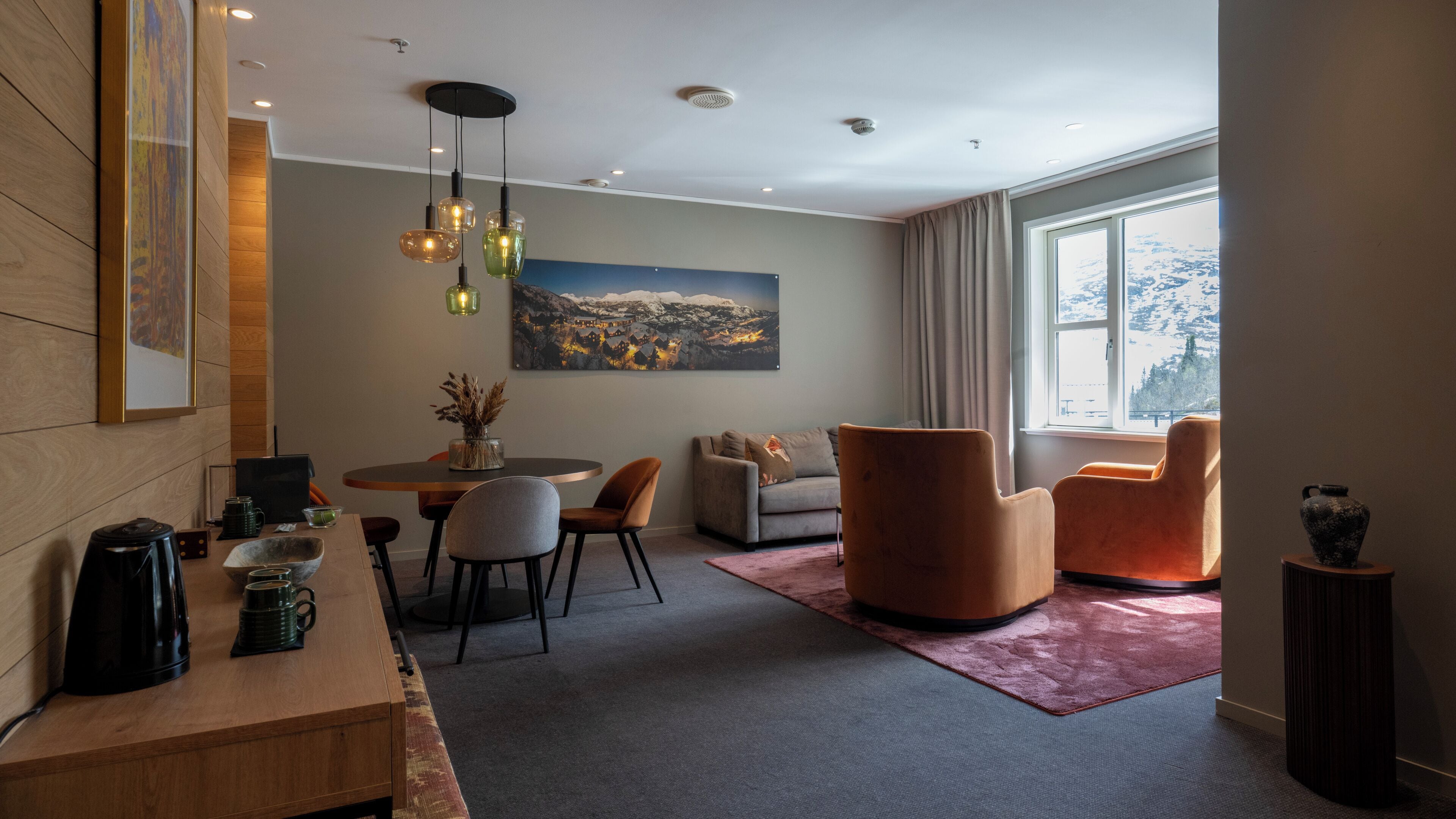 A modern living room with a dining area, a sofa, and a coffee table.