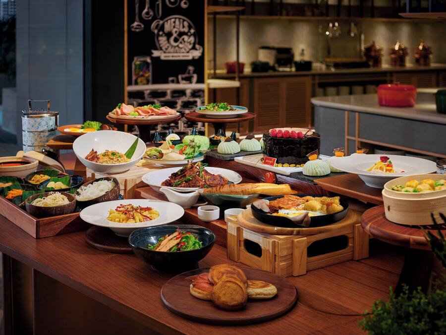 A buffet with various dishes and desserts.