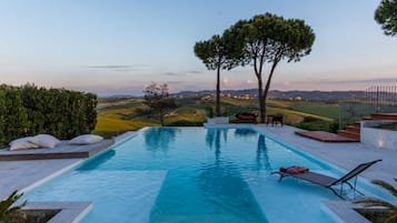 Relax by the pool surrounded by a beautifully maintained garden and scenic views.