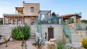 A stone building with a glass staircase and a door.