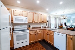 Enjoy cooking in this well-equipped kitchen with a double oven, dishwasher, and ample counter space.