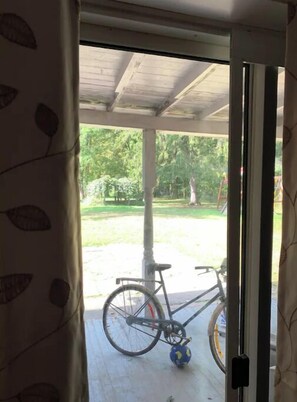 Guests can enjoy a patio with a view of the surrounding yard and trees.