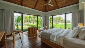 A bedroom with a wooden ceiling, a bed, a desk, and a chair. - Villa Lumia - 4BR · 20m Pool · Jacuzzi · Private Chef · Rice Fields · Ubud (Ubud)