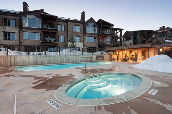 A modern building with a pool area, including a hot tub and a standard pool. - Silver Star 4302 | Apres Ski Hot Tub (Park City)