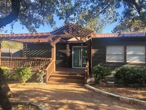 Step into this charming home, featuring a covered porch, garden, and a cozy front entrance.