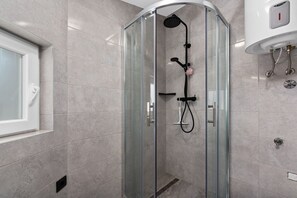 Shower, hair dryer, towels, toilet paper