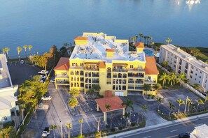 A multi-story hotel with a rooftop pool and several balconies.