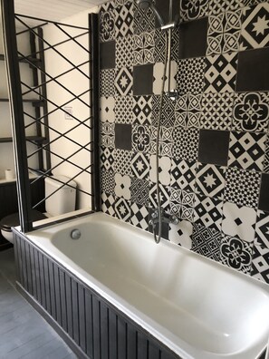 Bathtub, hair dryer, towels, soap