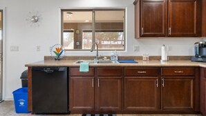 A kitchen with wooden cabinets, a dishwasher, a sink, and a window. - Phx Escape CENTRAL family pet friendly 4 bd sleeps 10 (Phoenix)