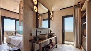 A modern bathroom with a large mirror, a wooden vanity, and a view of the sea. - Noma Milos - Delmar Collection (Milos)