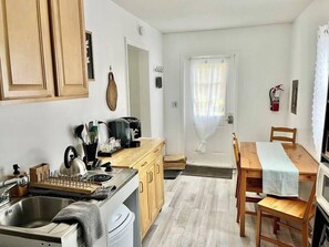 Fridge, microwave, coffee/tea maker, cookware/dishes/utensils