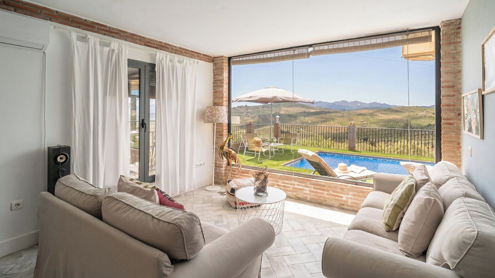 Un grand balcon avec une piscine, un canapé et une table.