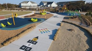 A playground with a hopscotch game, sandpit, and swings. - 🌊 1 Min to Beach! 🏊 Heated Pool | 🛺 Golf Cart | 🛗 Elevator | Ocean Views! (Nagshead)