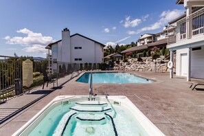 Relax by the pool surrounded by a scenic view of distant mountains.