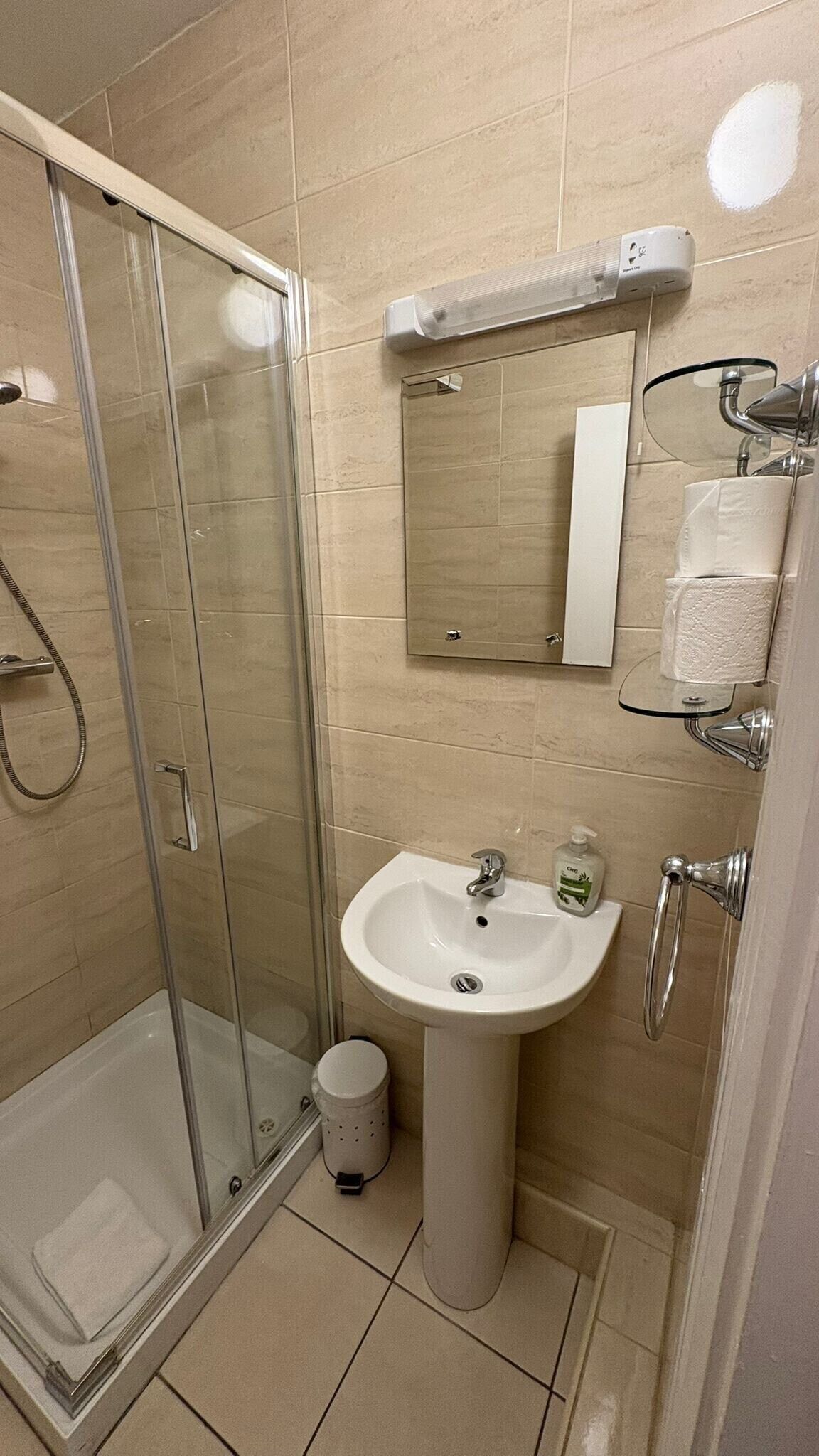 Shower, hair dryer, towels, toilet paper