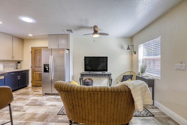 A compact living space with a kitchenette, a television, a ceiling fan, and a window with blinds. - Centennial Hills Luxury Guesthouse In Northwest Las Vegas (Las Vegas)