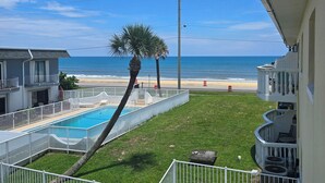 A pool area with a view of the beach and ocean. - Private 2 bedroom 1 bath with pool, beach, wifi, near Daytona & I-4 to Orlando (Ormond Beach)