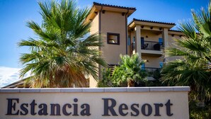 A sign for Estancia Resort with a building in the background. - Bike, Hike, Swim, Explore 5 Star Resort - Guaranteed FUN & Memories (St. George)