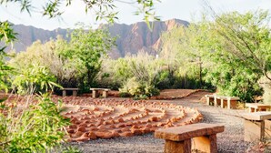 A garden with a stone pathway, benches, and a variety of shrubs and trees. - Bike, Hike, Swim, Explore 5 Star Resort - Guaranteed FUN & Memories (St. George)
